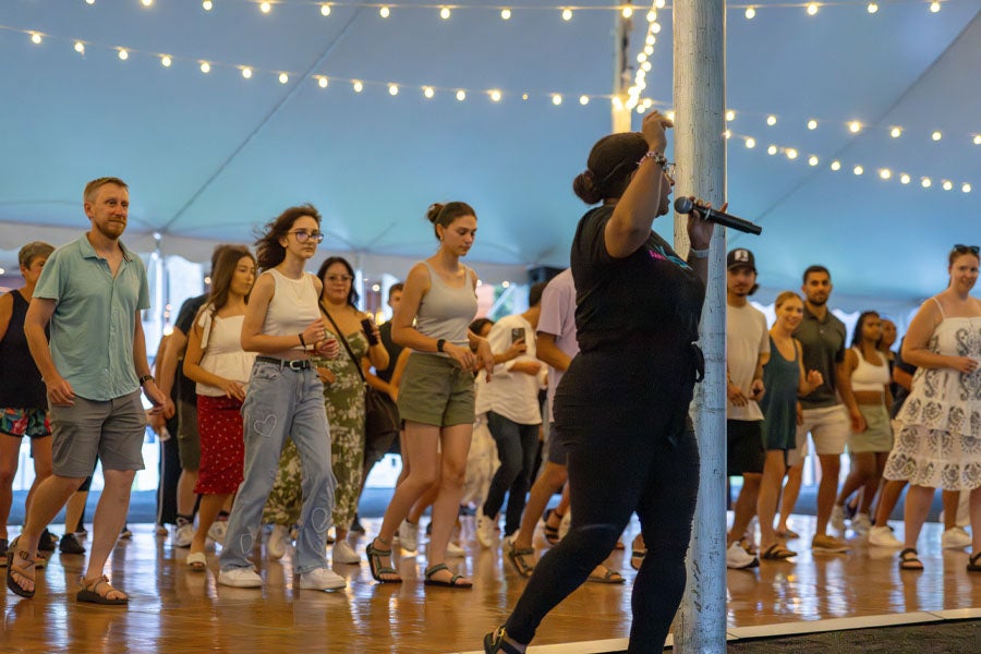 A group of concertgoers participating in a dance lesson